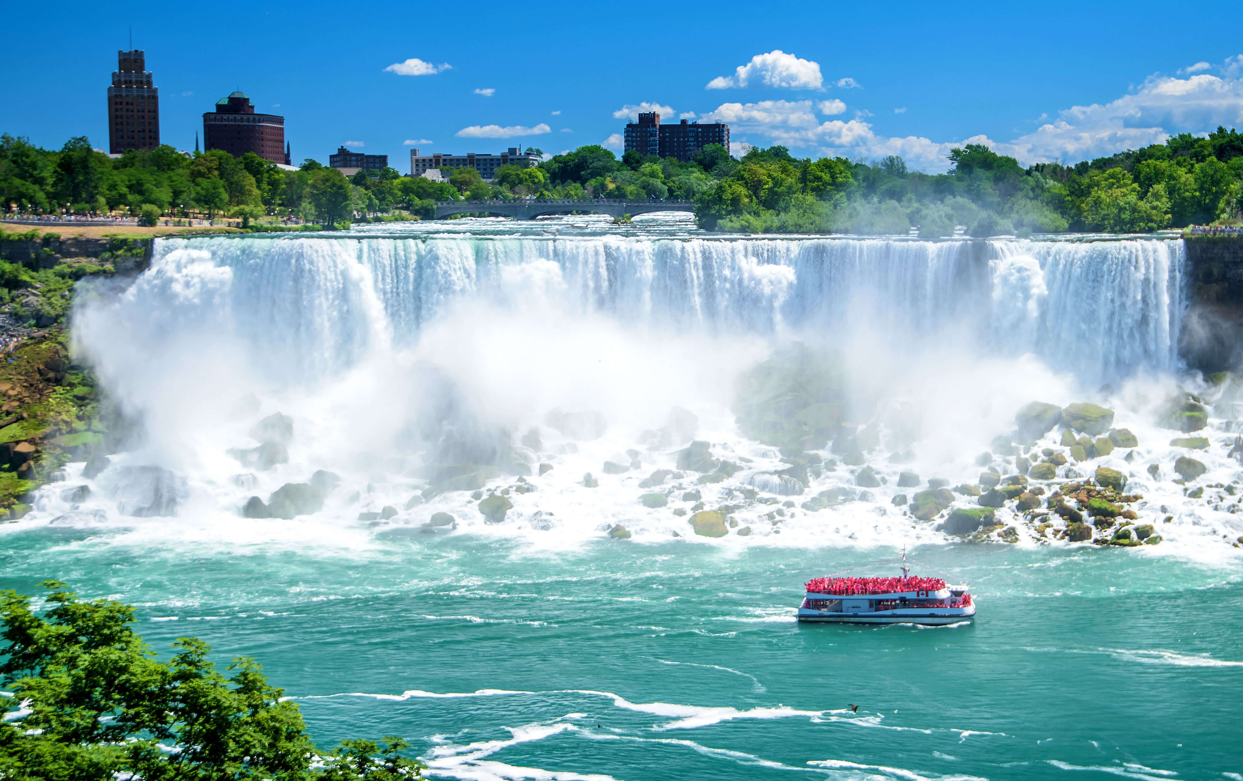 Stunning view of Niagara Falls in Canada with a tour boat approaching the waterfall